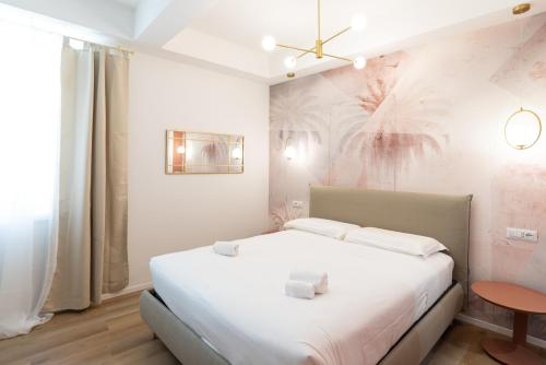 a bedroom with a white bed and a table at Maison Rasella Palace Suites in Rome