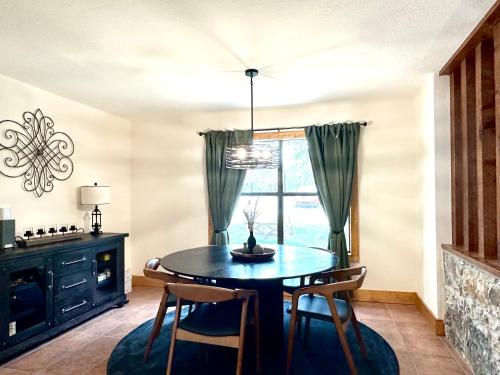 a dining room with a table and chairs and a window at Sanctuary on the Frio in Concan