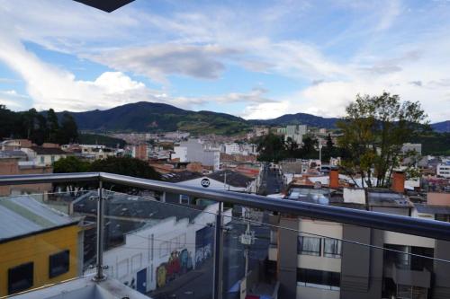 a view of a city from a balcony at Hotel Ariston in Pasto