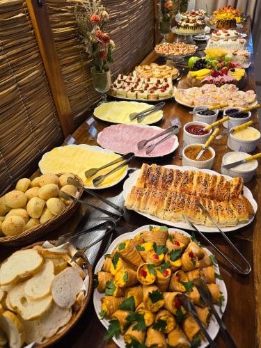 a table topped with lots of different types of food at Navega Hotéis in Navegantes