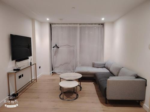 a living room with a couch and a table at Spacious 2 bedroom flat by the Tower in London