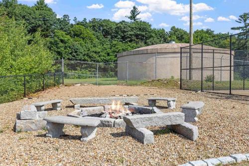 a fire pit with benches in a park at Cedar Lodge Room-Private Balcony Close to Weirs! in Laconia