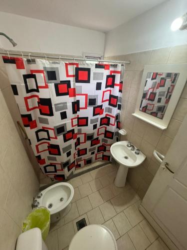 a bathroom with a toilet and a sink at Alem 21 in Villa María