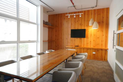 a conference room with a long wooden table and chairs at Dara Al Yammamah Hotel - Formerly Nuzl Shada in Jeddah