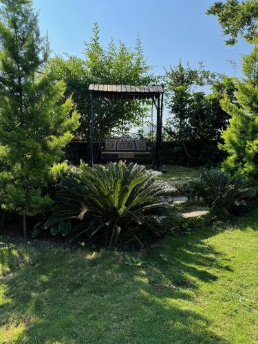 a park with a bench in the middle of a yard at Karinya Villas in Nainital