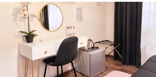 a white desk with a black chair and a mirror at Le Sciantose Relais in Naples