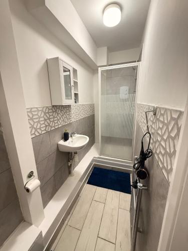 a small bathroom with a sink and a shower at The Aqua Stay in city centre in Chesterton