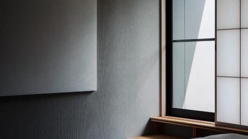a room with a window and a cabinet at 別府ホテル塒 Beppu Hotel Negura in Beppu