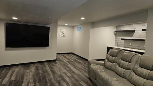 a living room with a couch and a flat screen tv at New, charming custom home in Sturgeon Bay