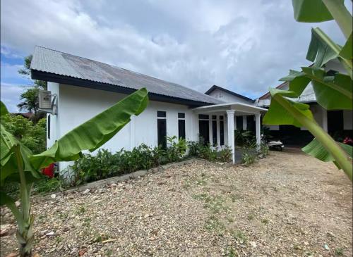 a house with a large yard in front of it at Stunning Family Friendly House Nearby Lampuuk Beach in Banda Aceh