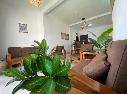 a living room with a couch and a table at Stunning Family Friendly House Nearby Lampuuk Beach in Banda Aceh
