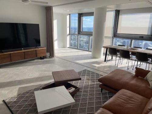 a living room with a flat screen tv and a couch at Queen's Wharf - Hosted by Nick in Brisbane