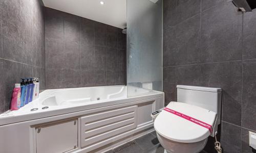 a bathroom with a white toilet and a bath tub at Hotel Yaja Cheongju Terminal Branch in Cheongju