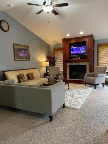 a living room with a couch and a tv at Urbandale Ranch in Urbandale