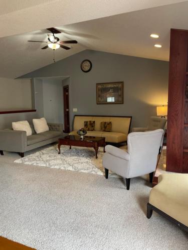 a living room with a couch and a table at Urbandale Ranch in Urbandale