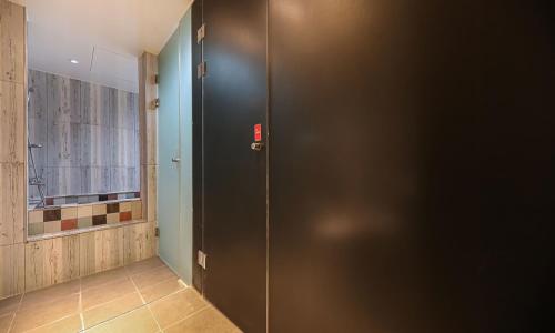 a black door in a room with a window at Hotel Yaja Cheongju Terminal Branch in Cheongju