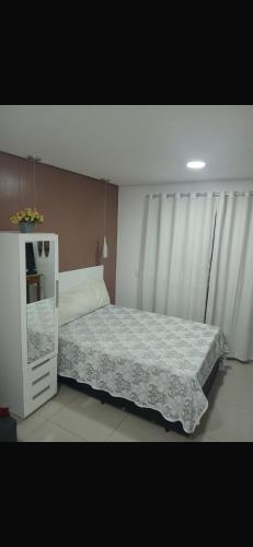 a bedroom with a bed and a white cabinet at Ap mobiliado reg central de São Paulo in São Paulo