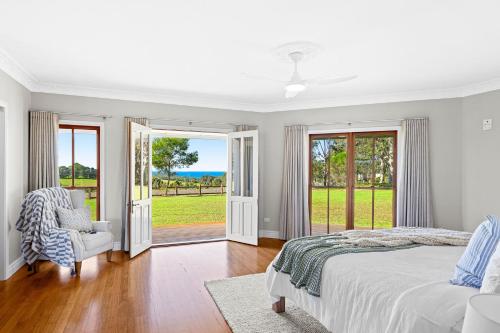a bedroom with a bed and a view of the ocean at 58 Mystery Bay Road, Mystery Bay in Central Tilba