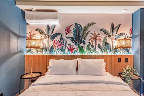 a bedroom with a large bed with a tropical mural at H201 I Luxury Loft I Central I Balcony With Views in Cali