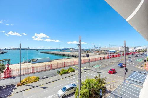 a view of a busy city street with cars on the road at Waterfront Loft at Quay, Walk to Ferry & Train in Auckland
