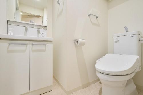 a white bathroom with a toilet and a sink at N 5min to waseda sta designer condo high security free wifi in Tokyo