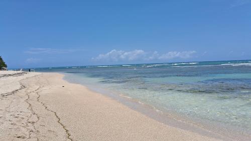 a sandy beach with the ocean in the background at CortLang Vacation Rentals, Costambar in San Felipe de Puerto Plata