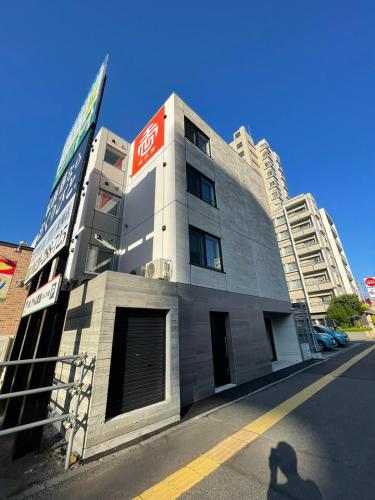 a building with a coke sign on the side of it at カレラ豊平2nd in Sapporo