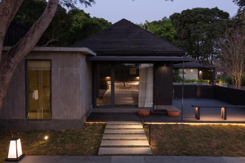 a house with a view of a bedroom at Sunset Garden Hotel in Gulang Yu