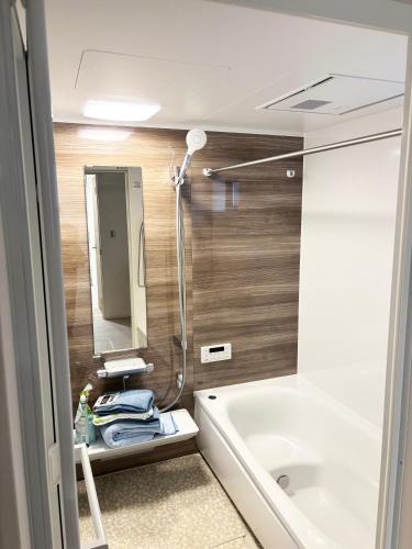 a bathroom with a bath tub and a sink at Beauty House in Tokyo