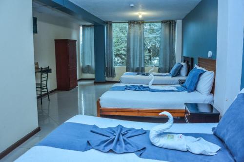 Postel nebo postele na pokoji v ubytování Hotel Miraflores