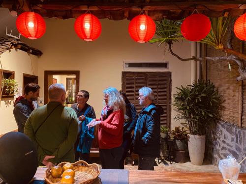 a group of people standing in a room with red lanterns at PIA homestay - Tours & Motorbike rentals - Cao Bằng in Cao Bằng