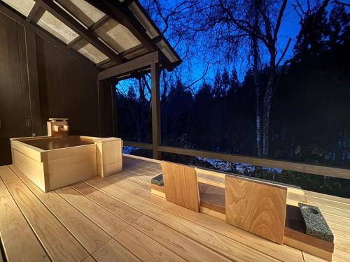 a bathroom with a sink on a deck at night at Miyama Ouan Kyoritsu Resort in Takayama