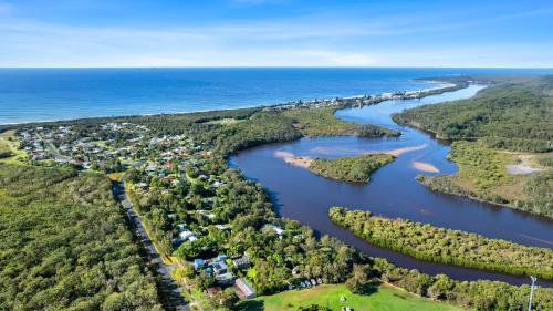 an aerial view of a river and a city at Wooli River Lodges in Wooli