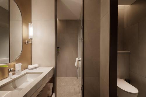 a bathroom with a sink and a mirror at Mlily Hotel in Shanghai