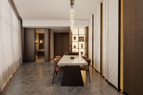 a dining room with a table and chairs at Mlily Hotel in Shanghai