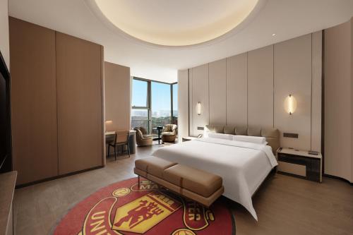 a bedroom with a large bed and a living room at Mlily Hotel in Shanghai