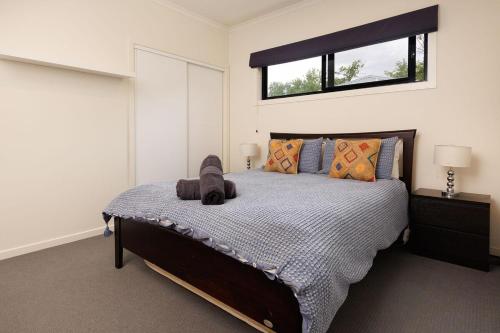 a bedroom with a large bed with a window at Little Palace on Buckingham in Lavington