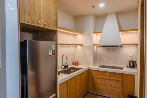 a kitchen with a stainless steel refrigerator and a sink at Colline Dalat in Da Lat