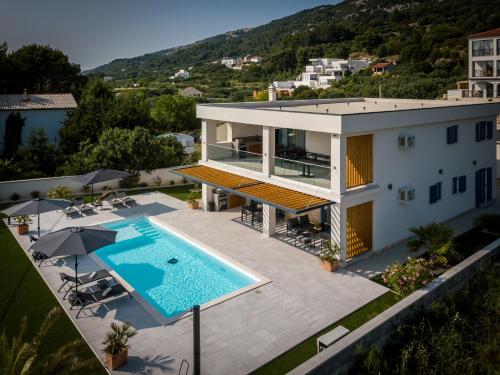 an aerial view of a house with a swimming pool at Villa Milamar in Banjol