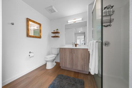 a bathroom with a sink and a toilet at Stylish Top-Floor Gem with King Bed & City Ocean Views in San Diego