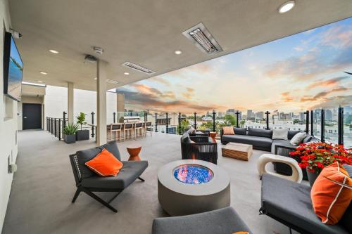 a living room with a mural of a sunset at Stylish Top-Floor Gem with King Bed & City Ocean Views in San Diego