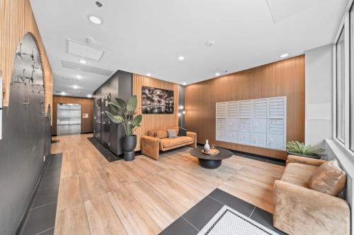 a living room with a couch and a table at Stylish Top-Floor Gem with King Bed & City Ocean Views in San Diego