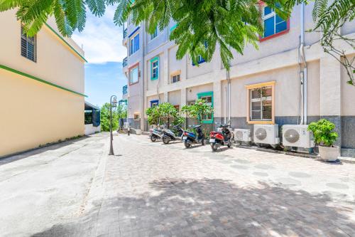 a street with motorcycles parked in front of a building at Sunset Mu Style Inn in Xiaoliuqiu
