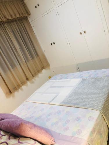 an empty bed in a room with a window at Apartamentos Las Palmeras, Benicàssim in Madrid