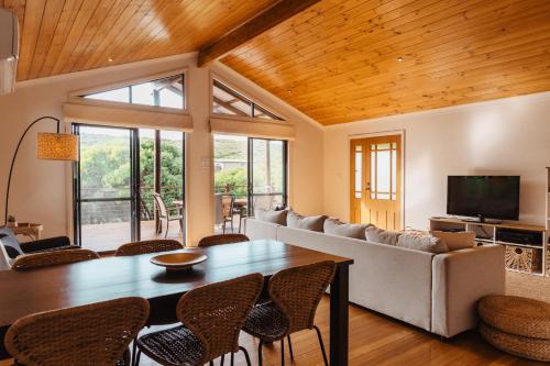 a living room with a table and a couch at Leeuwin Rise - Gnarabup in Gnarabup