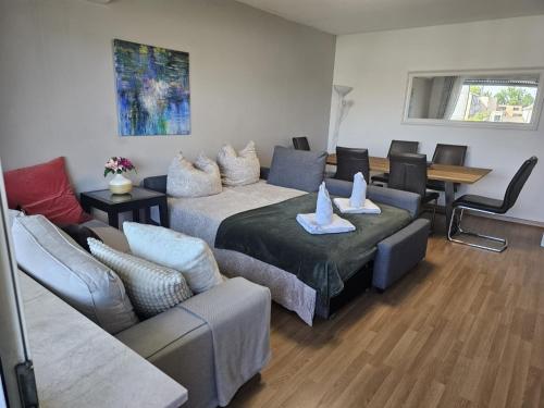 a living room with two beds and a couch at Moderne Wohnungen am Bahnhof Dachau mit direkter S-Bahn Verbindung nach München in Dachau