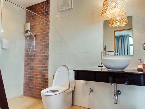 a bathroom with a toilet and a sink at Tantai Eco Farm Stay At Khao Yai in Ban Sap Noi