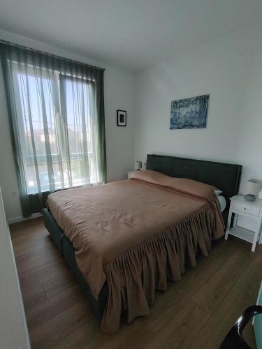 a bedroom with a large bed with a large window at Apartment Sulmare in Brodarica