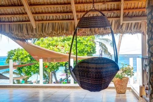 a hanging hammock in a resort with a view of the ocean at Hotel Villa Taina in Cabarete