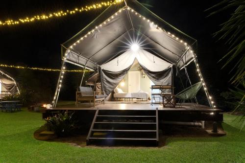 a tent with lights in a yard at night at South Coast Retreat in Greenwell Point